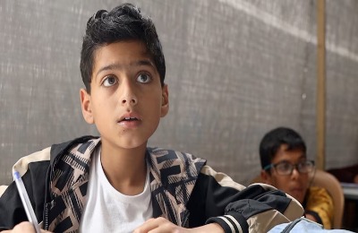 Yusuf studying mathematics, focused on education